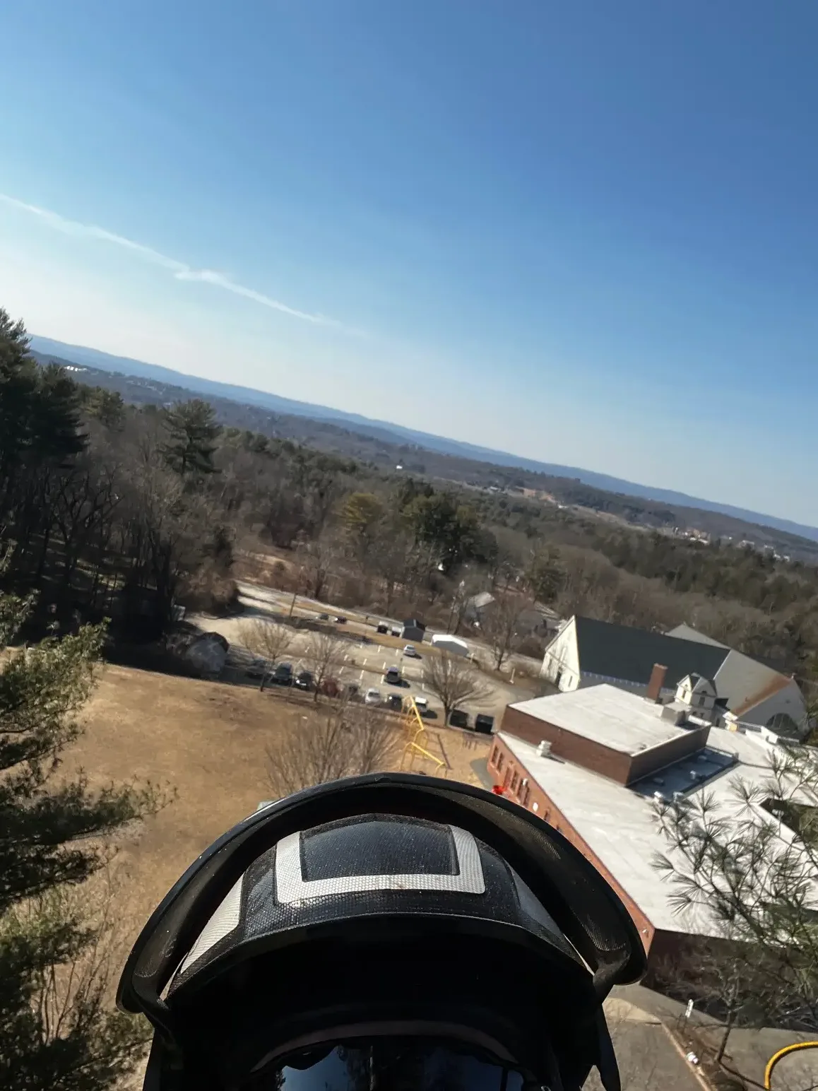 View from the aerial lift over the Pioneer Valley, with the arborist's helmet in the foreground